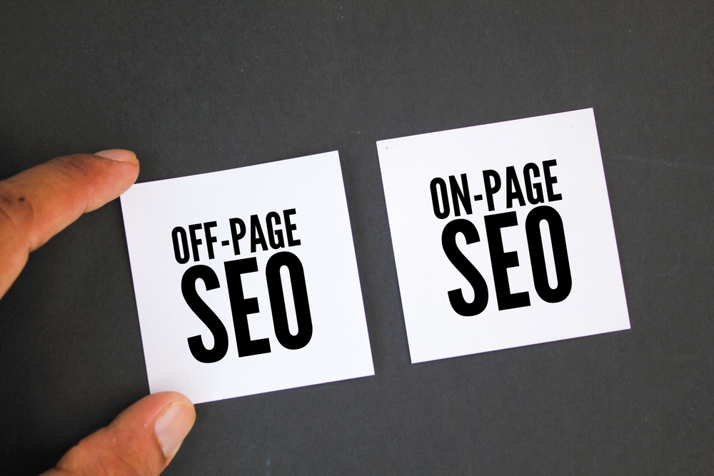 SEO specialist Wencidon David's hand holding a piece of paper with the words off page and on page SEO on